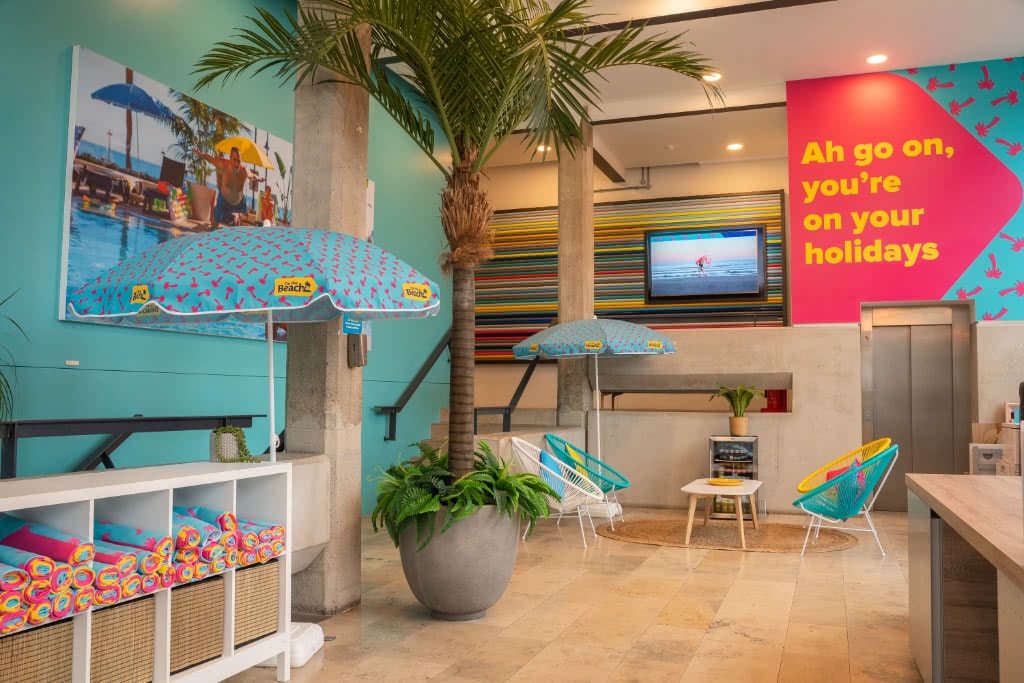 The On the Beach office reception decorated with parasols, beach towels and brightly coloured furniture